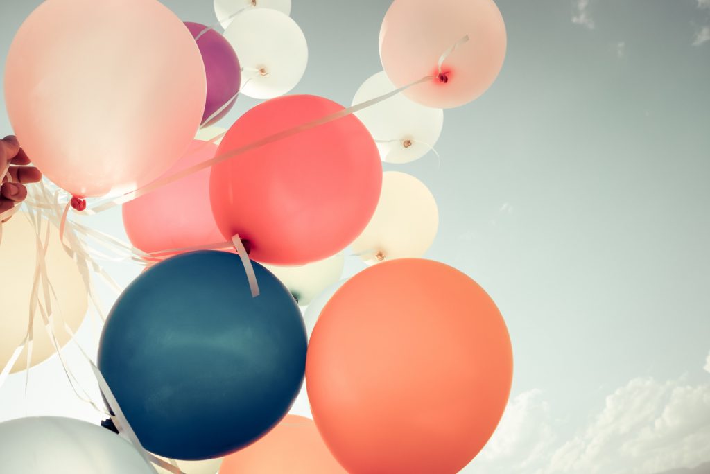 Colorful balloons flying on sky with a retro vintage filter effect. 