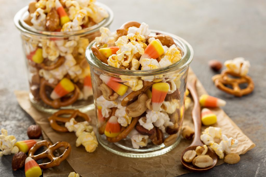 Homemade Halloween trail mix with candy corn, popcorn and pretzels.