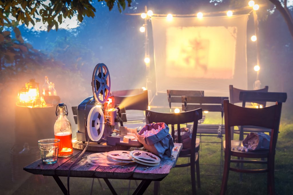 Small cinema in the summer garden in the evening.