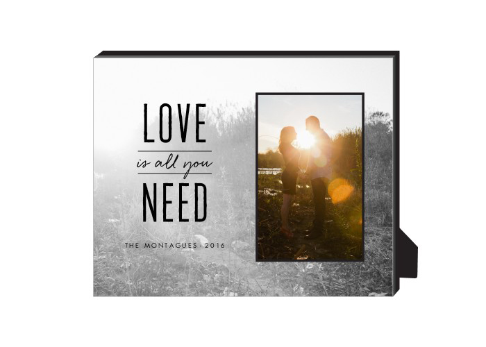 A personalized frame that says "love is all we need."
