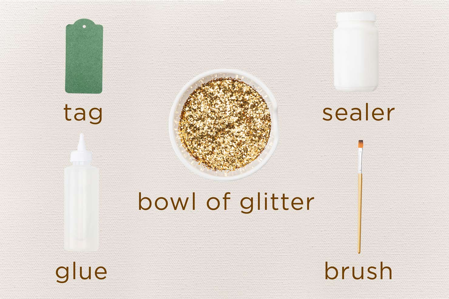 materials for making a glittered gift tag.
