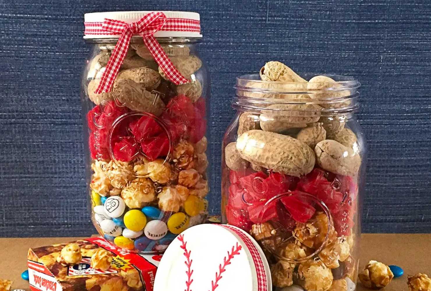 Trail mix in mason jar with lid decorated like a baseball.