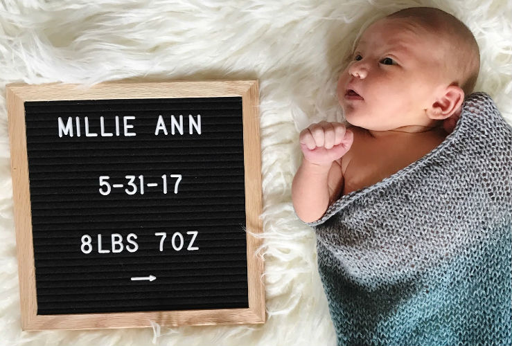 baby looking at a letter board