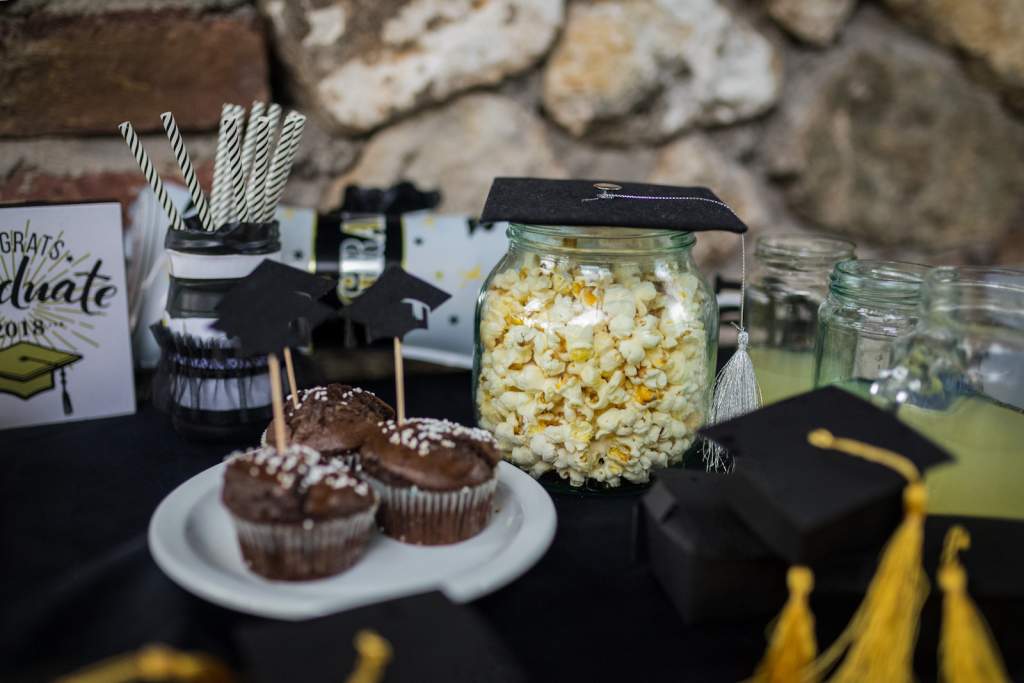 Graduation party table with brownies and popcorn