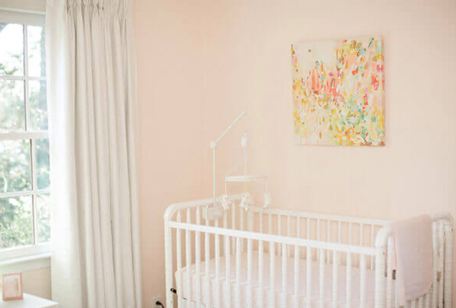 Light pink baby nursery decor.
