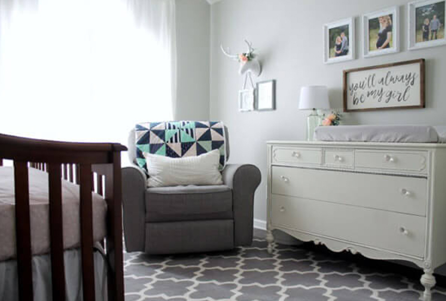 Gray nursery with rocking chair and changing table.
