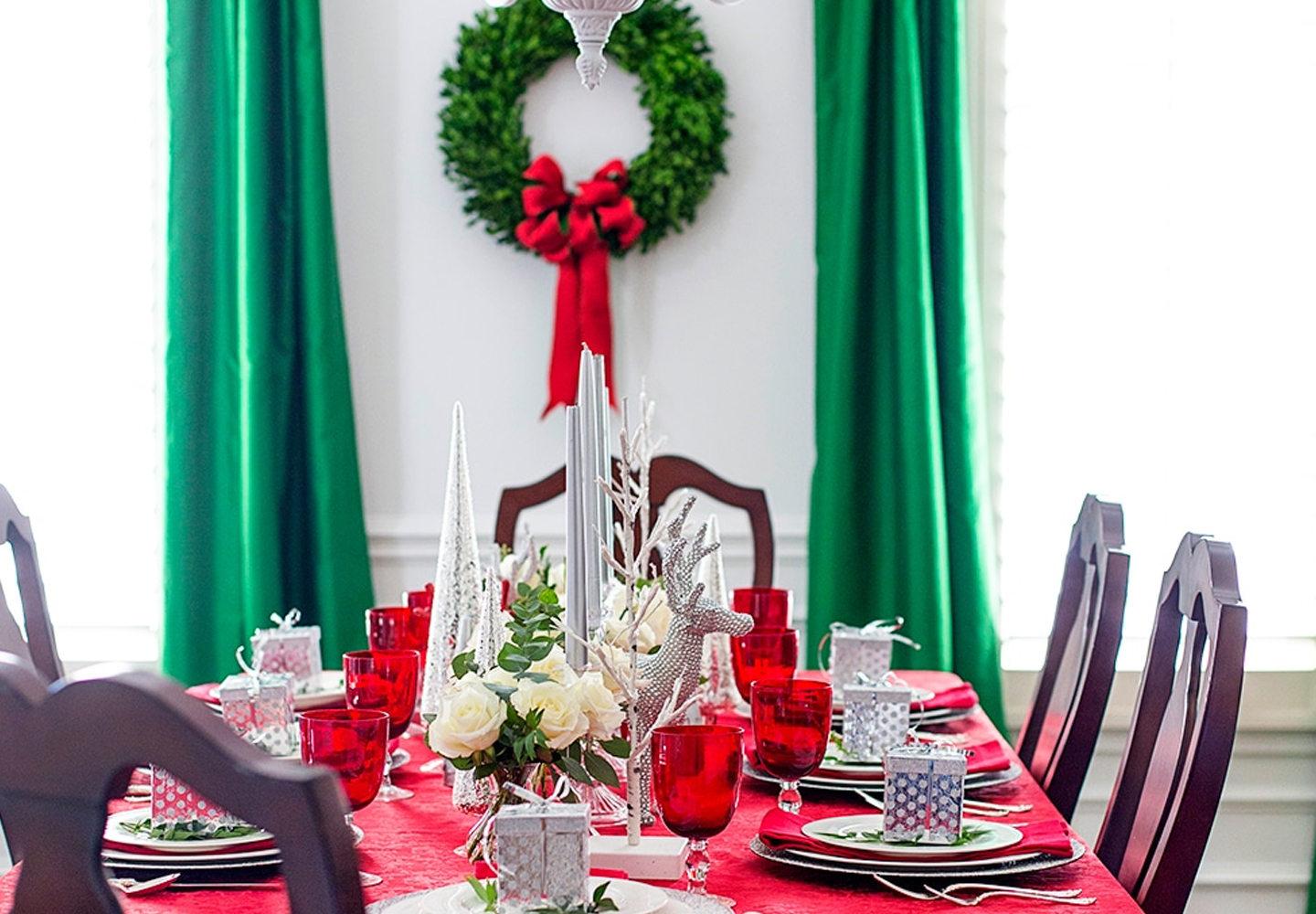 Classic red, white and green holiday dinner table setup. 