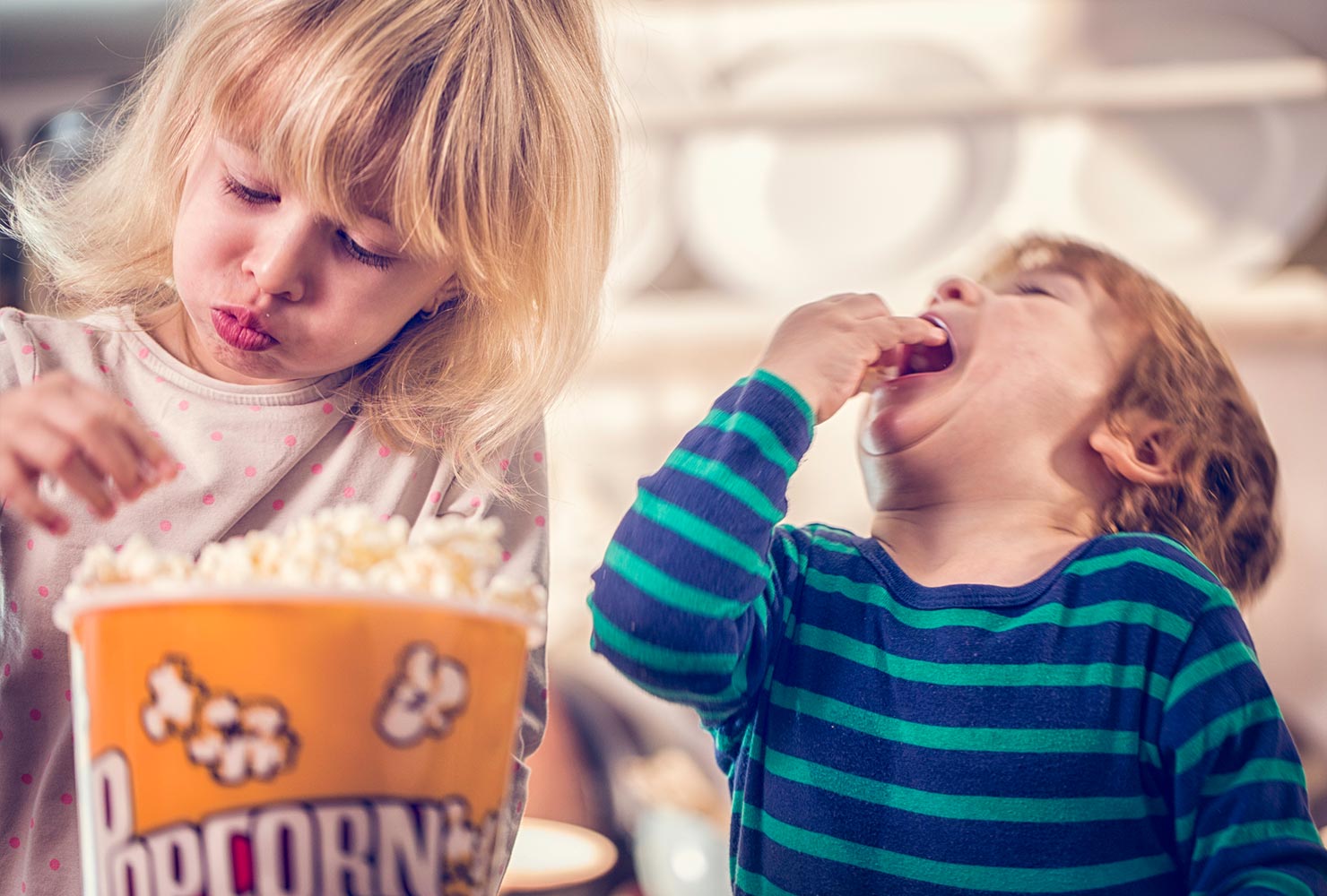 little kids eating popcorn