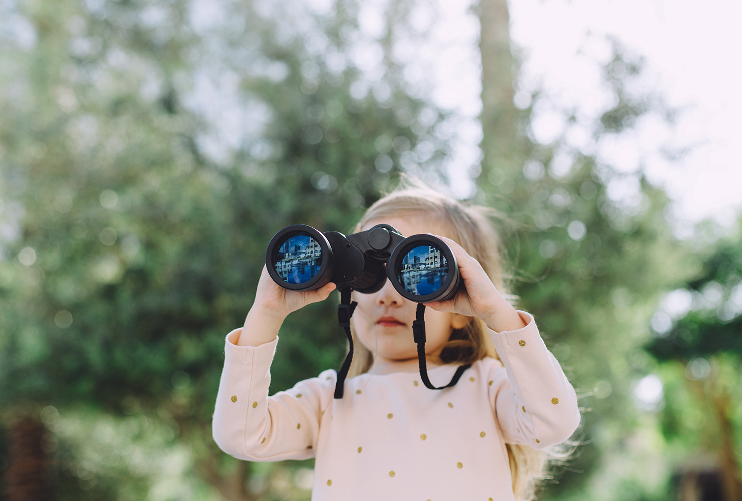 little girl looking through binoculars 