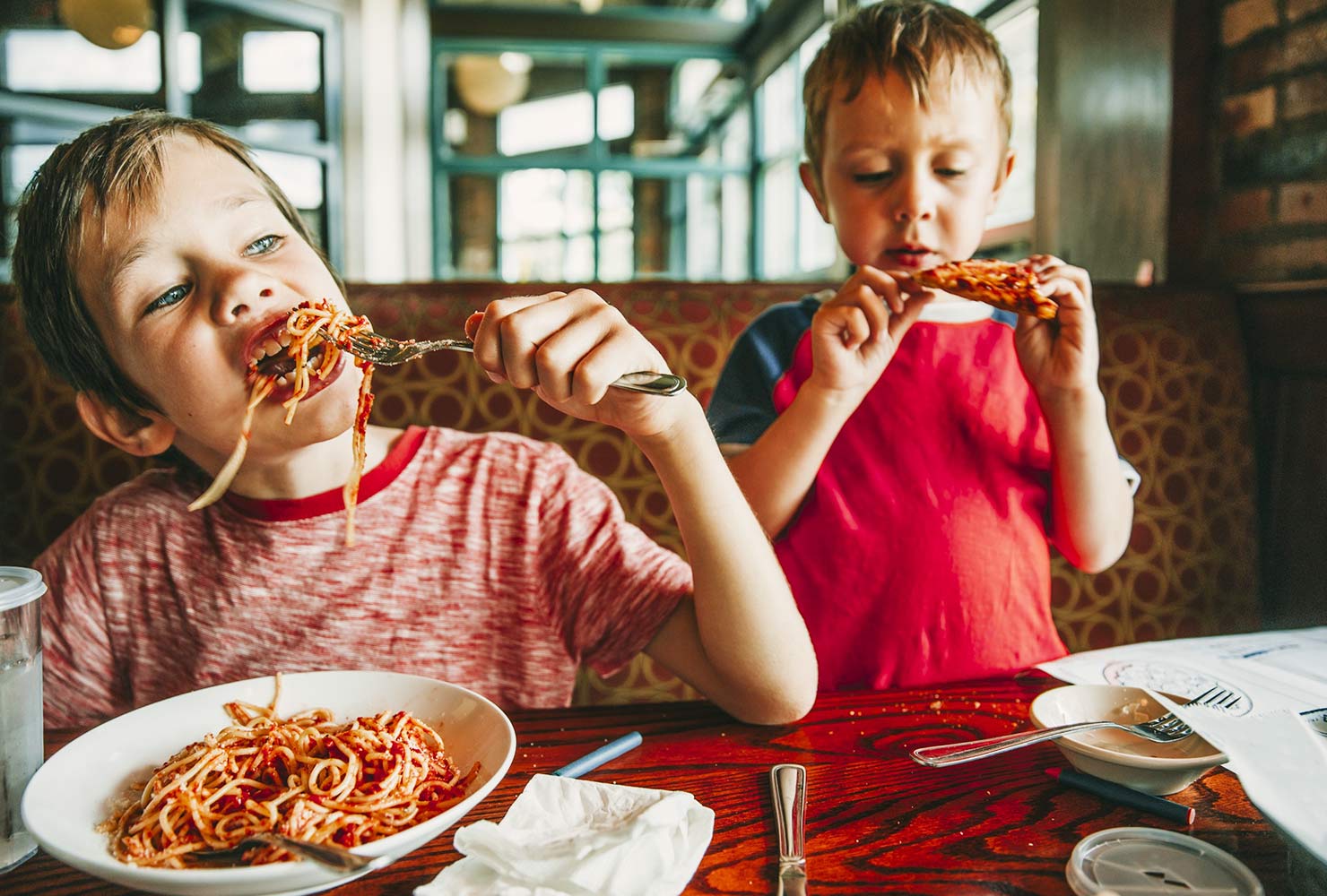 kids eating spaghetti and pizza