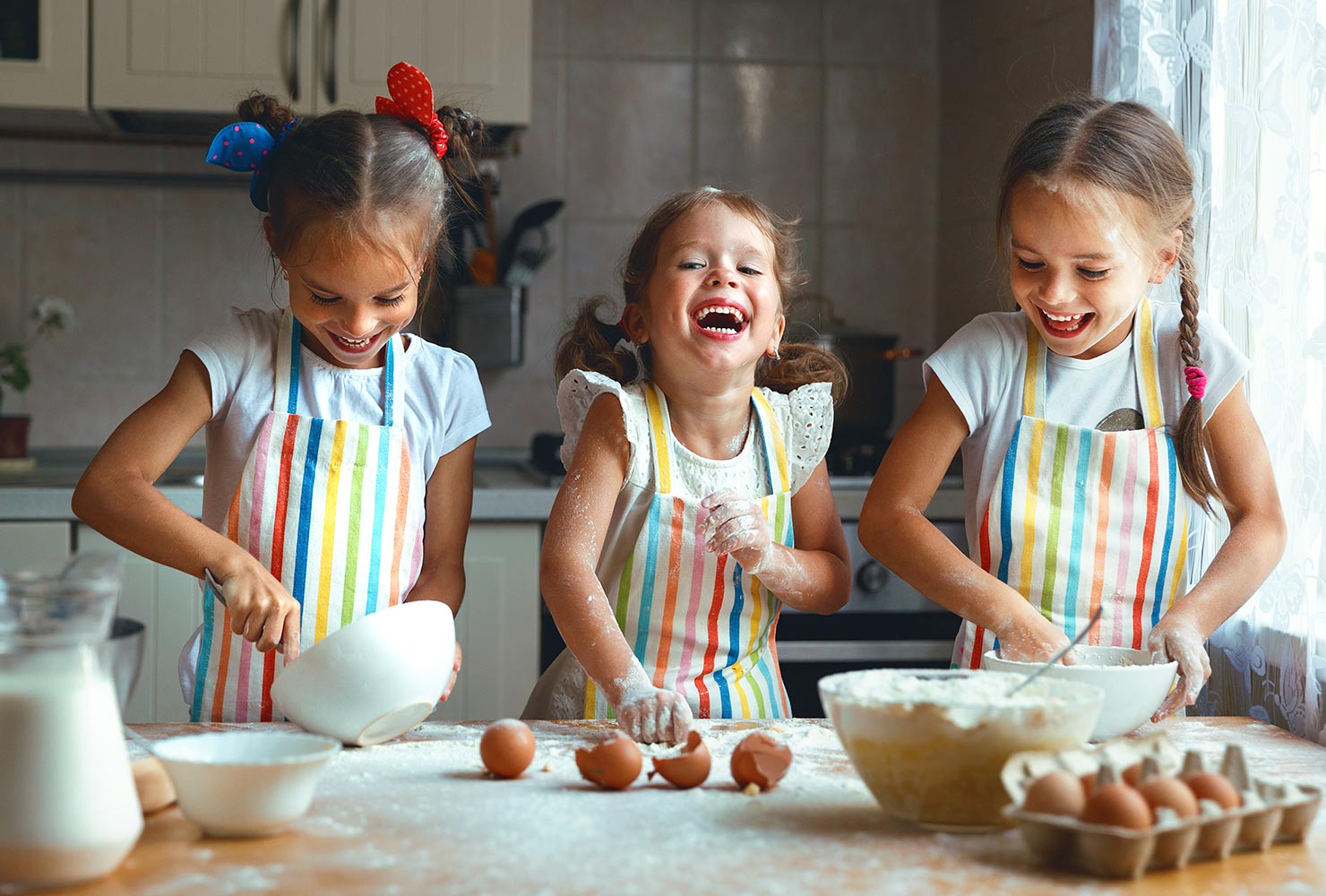 three girls baking cookies