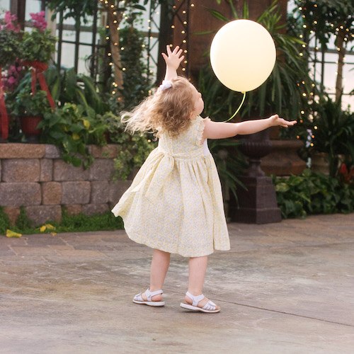 little girl chasing balloon