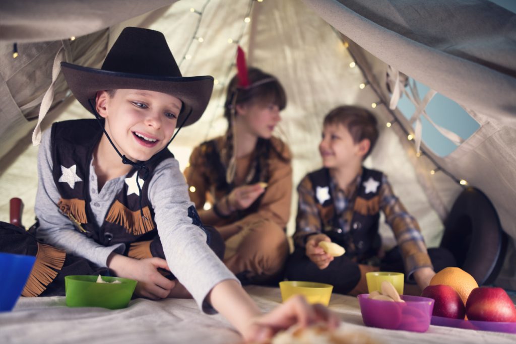Friends having cowboy party party in a tent. 