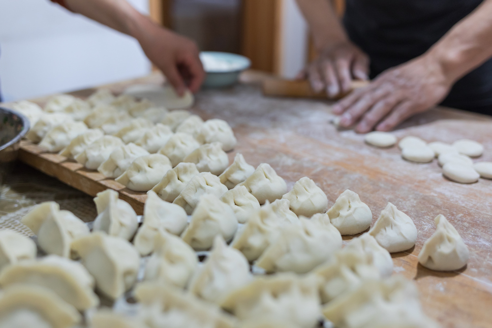 a familky makes dumplings for their family traditions