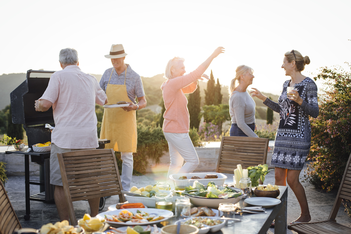 after the right dinner invitation wording, a group celebrates a dinner party outdoors