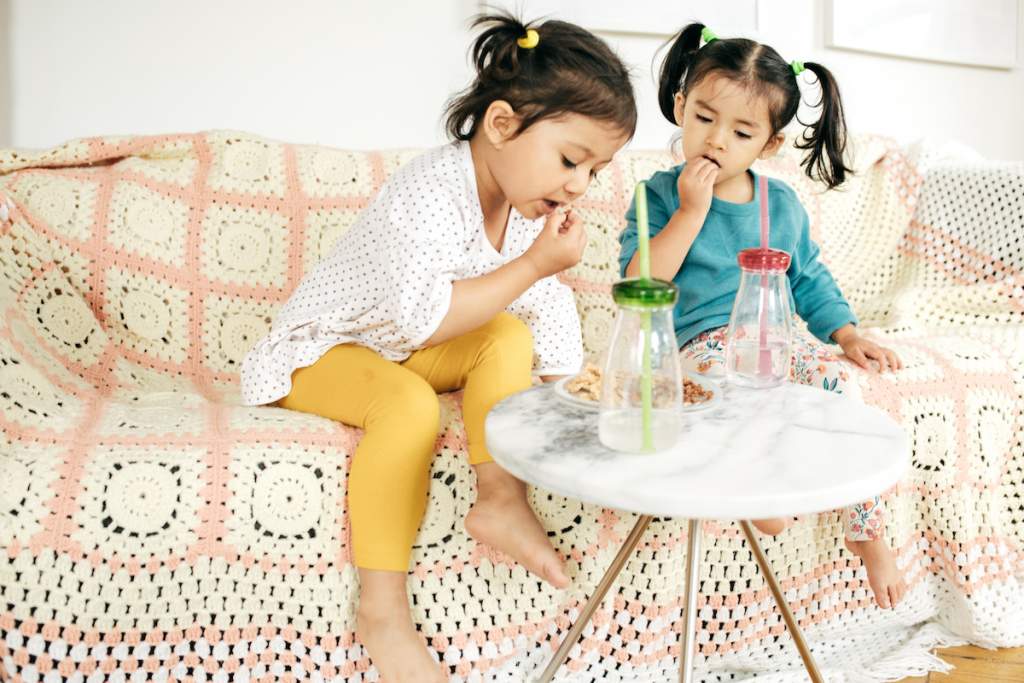 2 years old girls enjoy snack time between playdate ideas