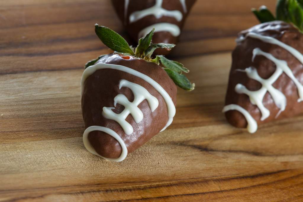 delicious chocolate covered strawberries made at home with a milk chocolate garnished making the strawberries look like a playing ball