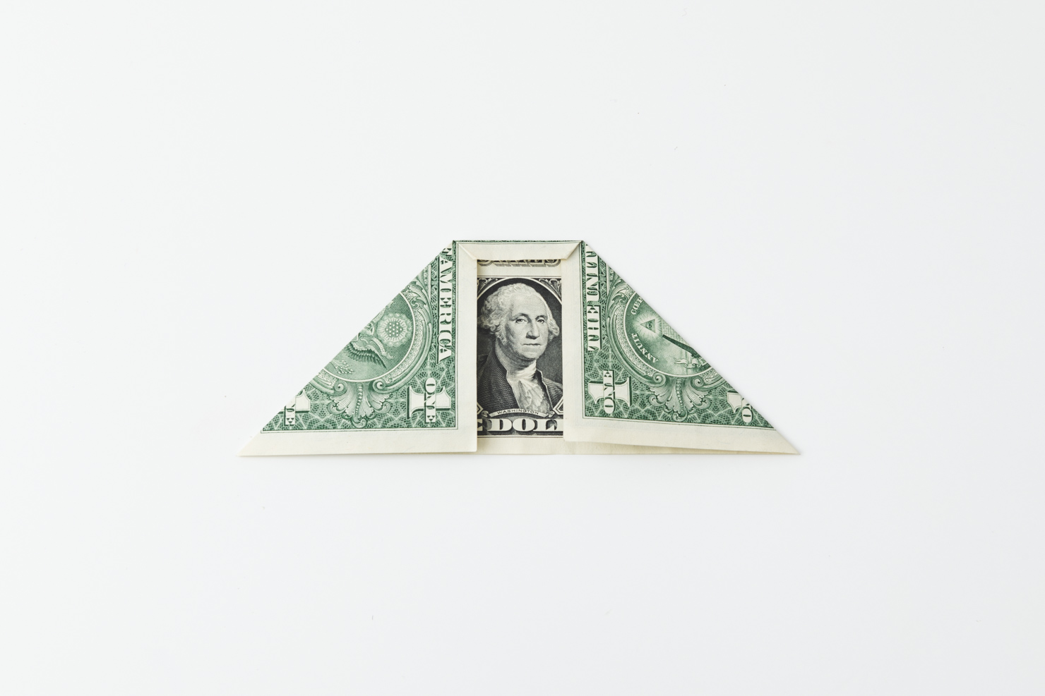 a dollar bill being folded at the top