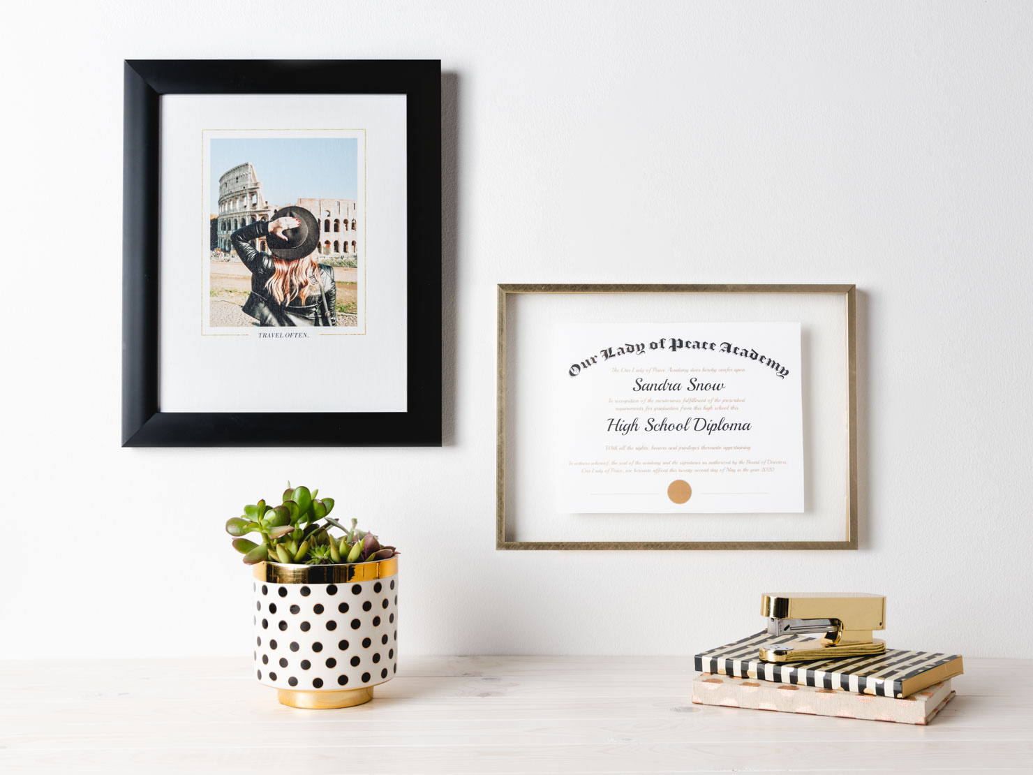 diploma next to a framed picture