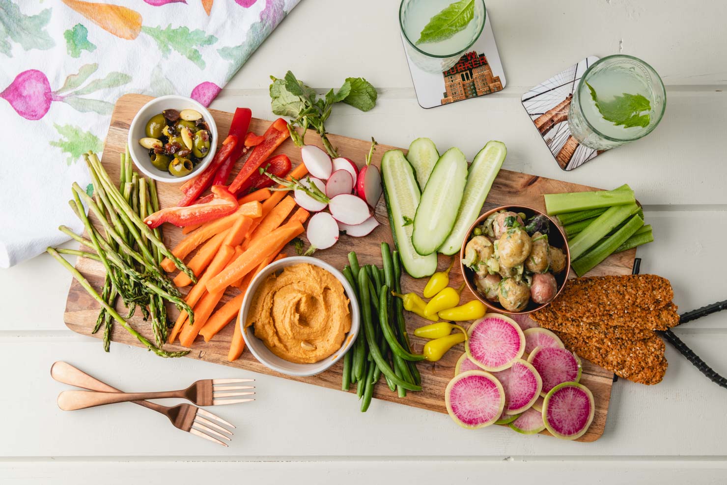 cutting board with veggies and dips
