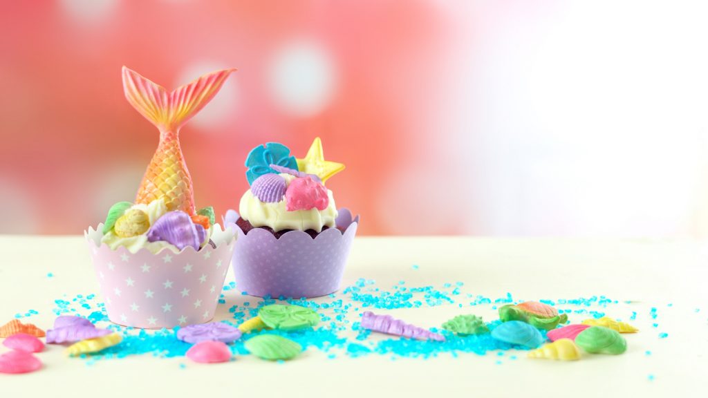 Mermaid theme cupcakes with colorful glitter tails, shells and sea creatures toppers for children's mermaid birthday Party