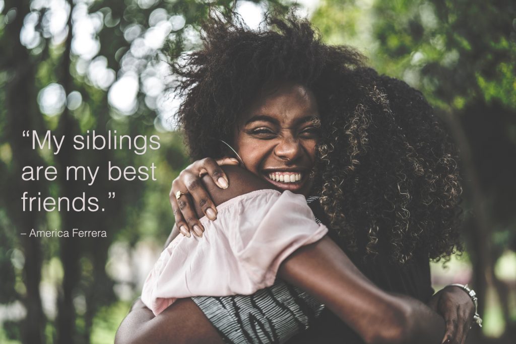 two siblings hug with a siblings quotes overlay