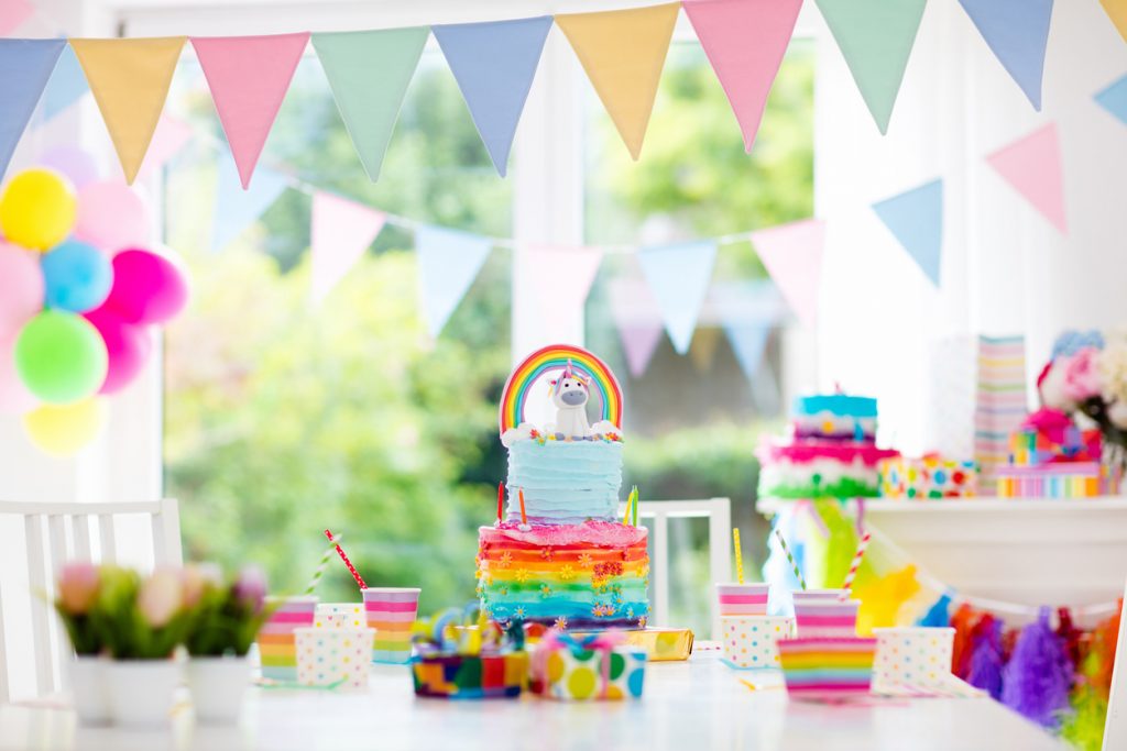 Rainbow banners and unicorn decor for birthday party