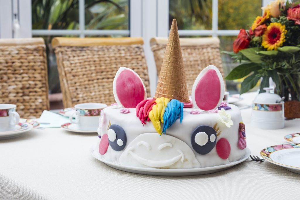 Homemade birthday cake unicorn on a table.