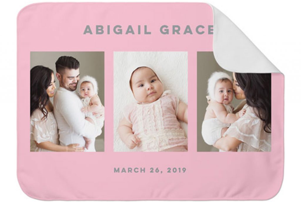 A cute pink baby blanket with photos.