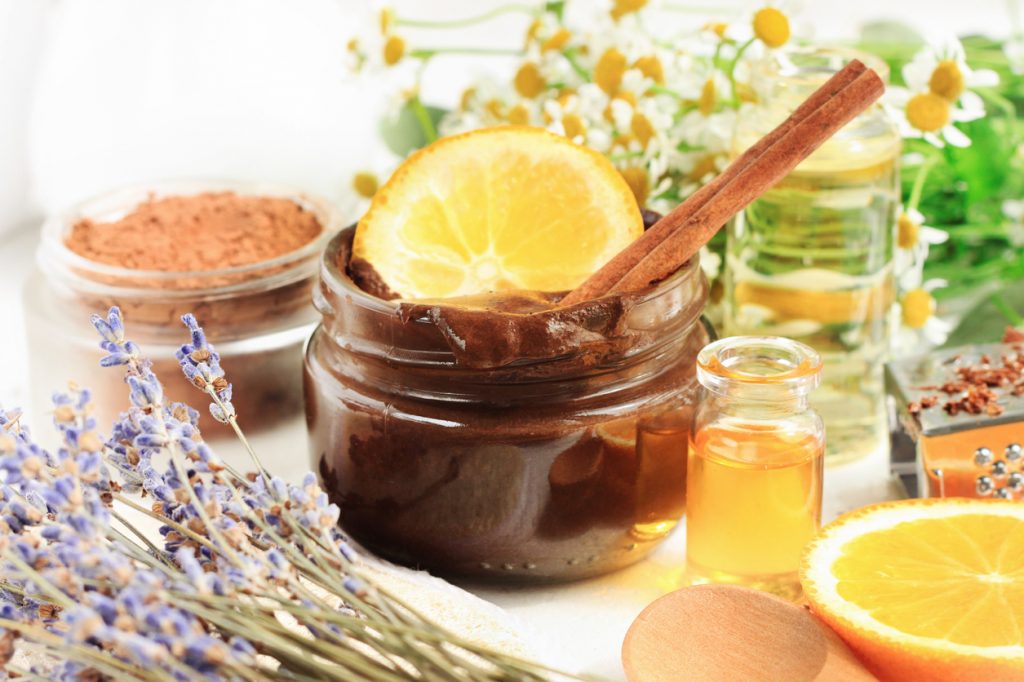 Jar of chocolate sugar scrub with aroma orange oil and lavender blossom.