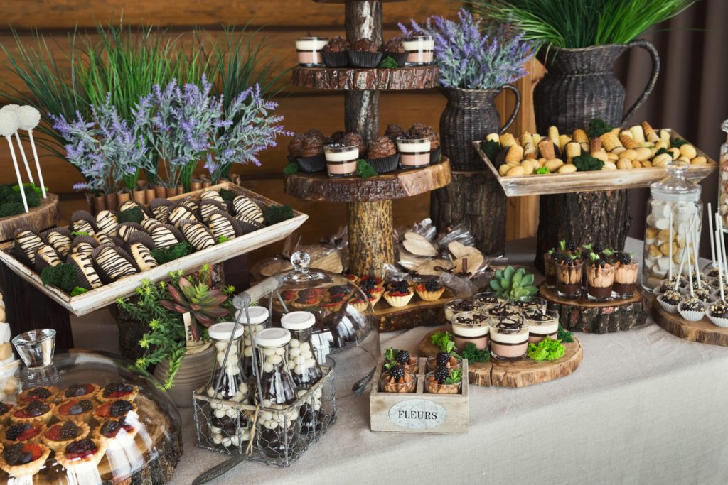 Candy bar for party against wooden background.