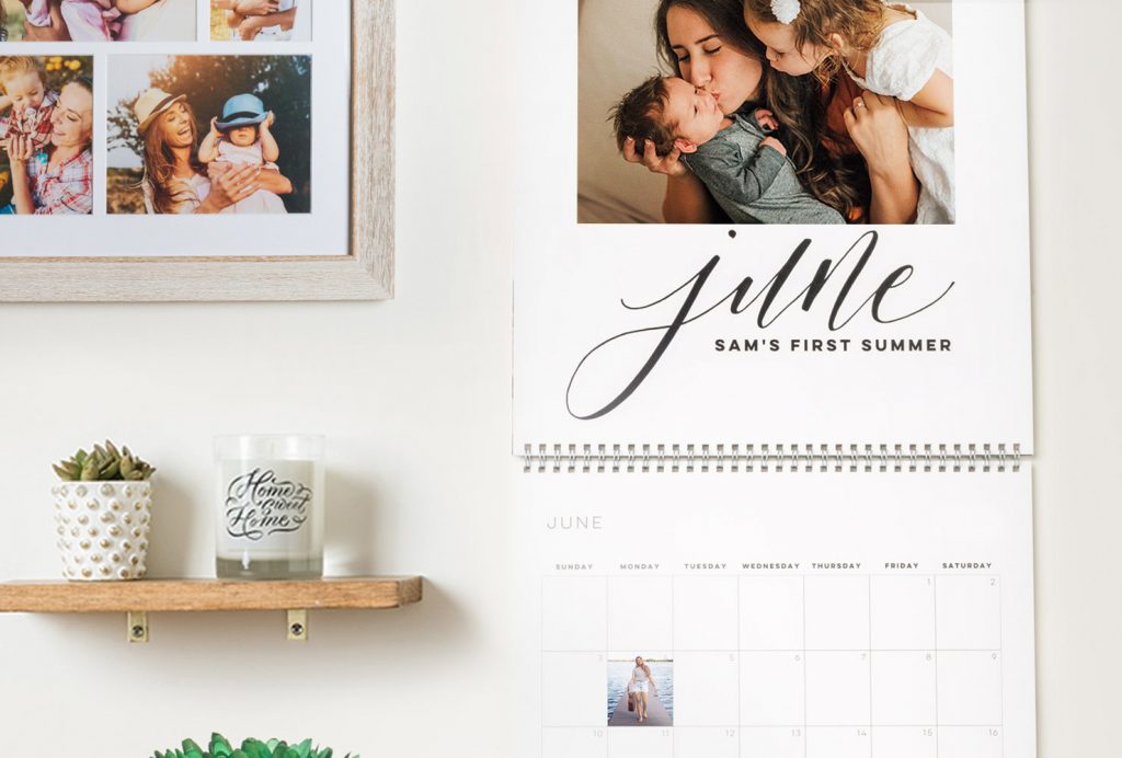 family wall calendar next to a candle