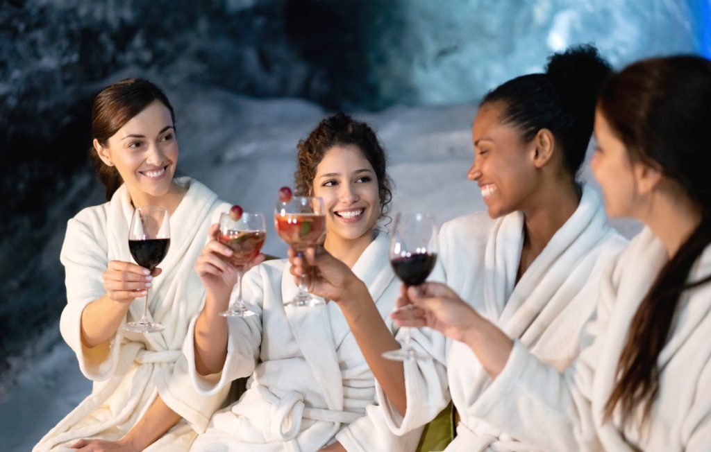 A group of women at the spa making a toast to the bachelorette.