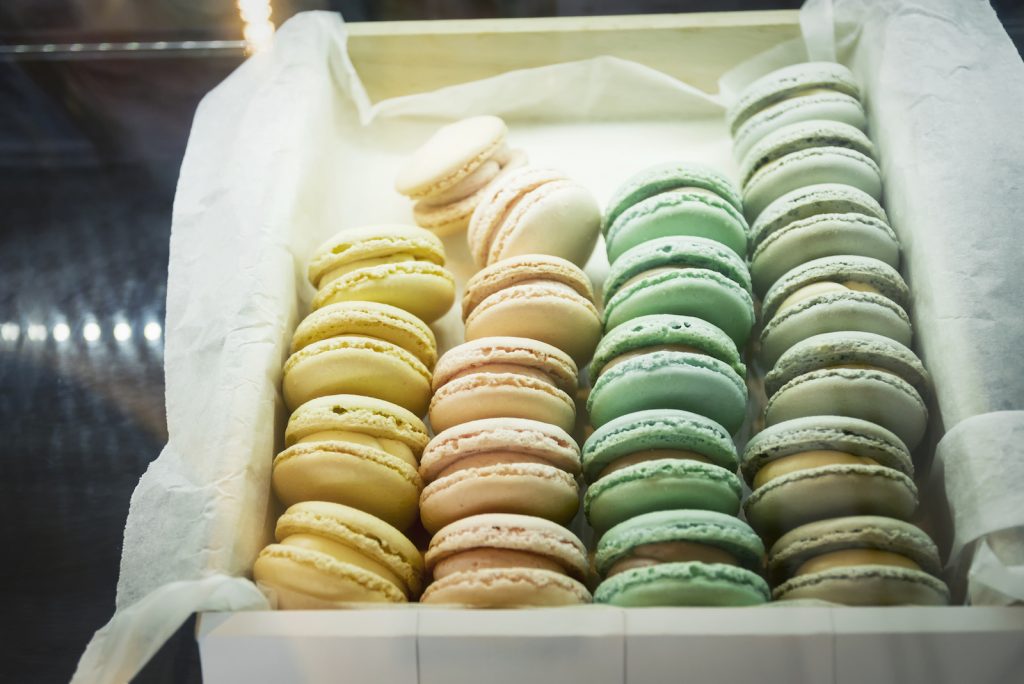 Mixed color of French macaroons in box.