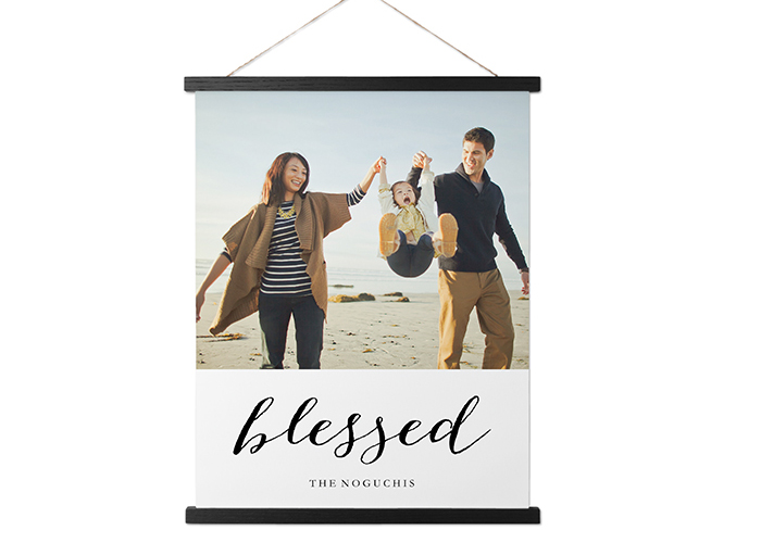 A hanging canvas print with a family photo and the word "blessed."