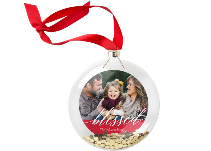 A family photo in a blessed Christmas ornament.