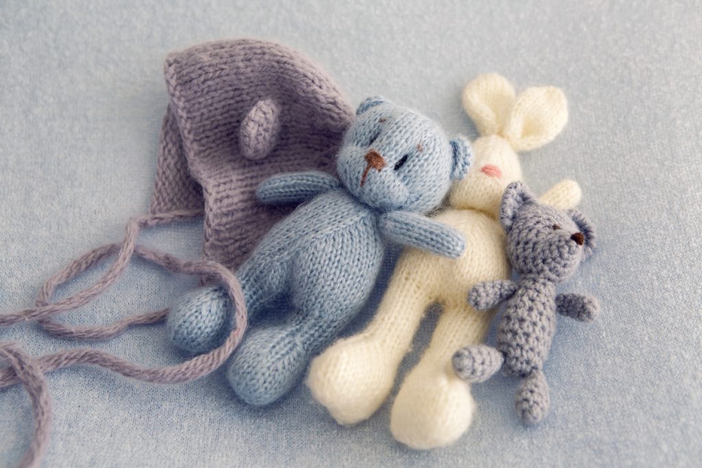 Three soft toy bears and a white hare made of crochet.