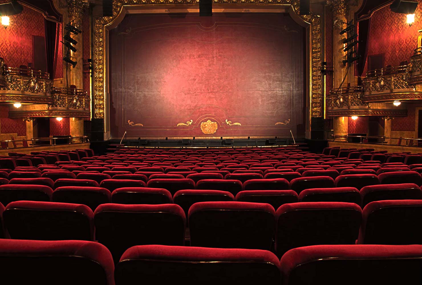 Theatre with red chairs.