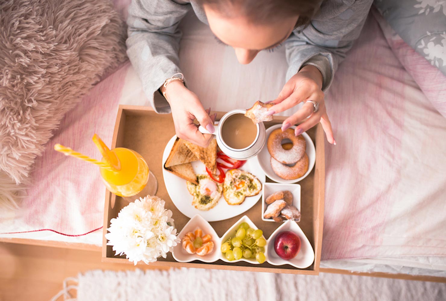 Girl eating breakfast in bed.