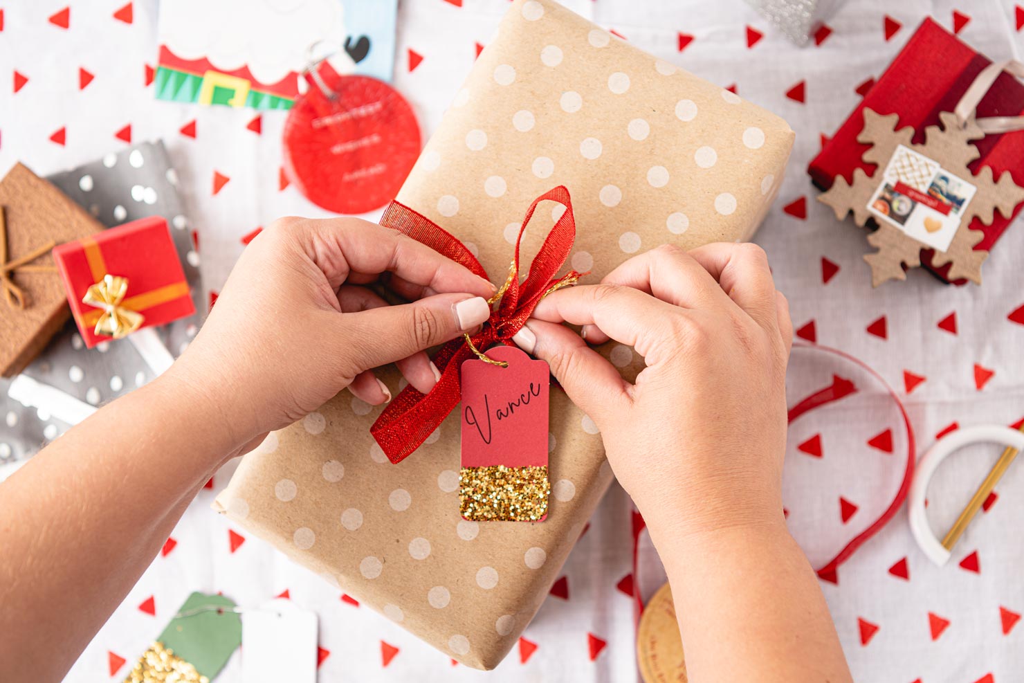a beautifully wrapped Christmas gift with a red gift tag. 