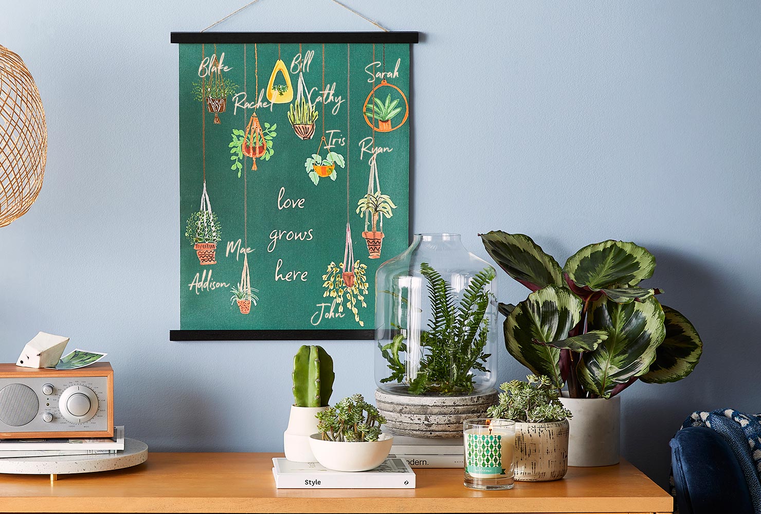 Art print with hanging planter and family names.