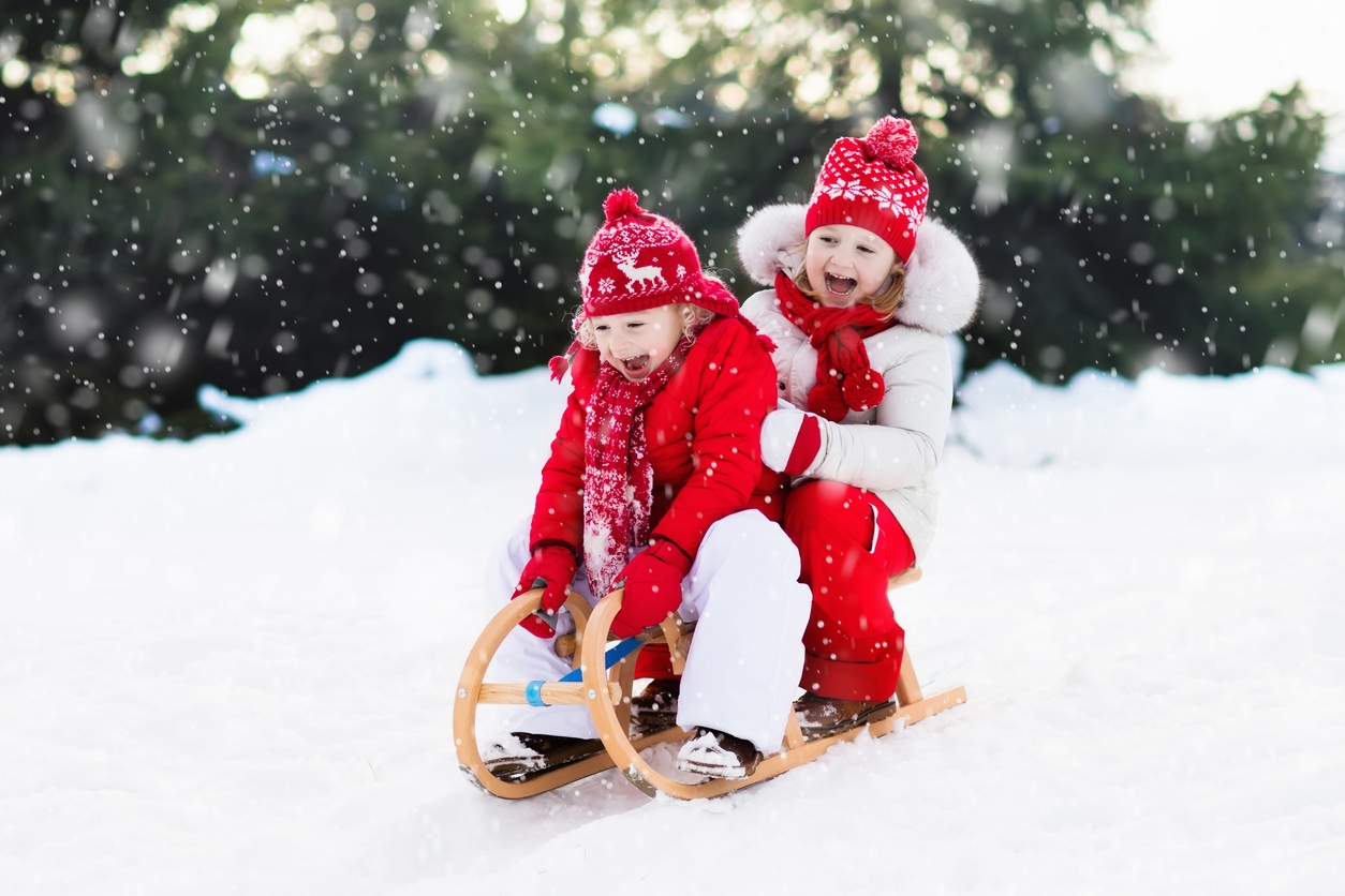 Kids on sleigh. Children sled. Winter snow fun.