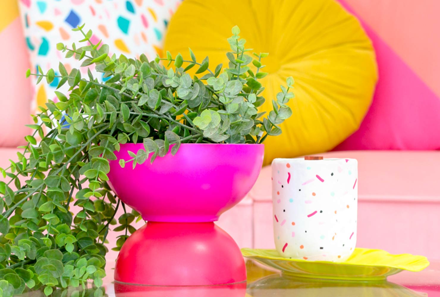 Pink planter with green plant.