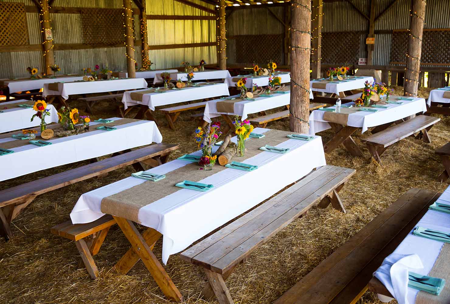 Barn with decorated picnic tables.
