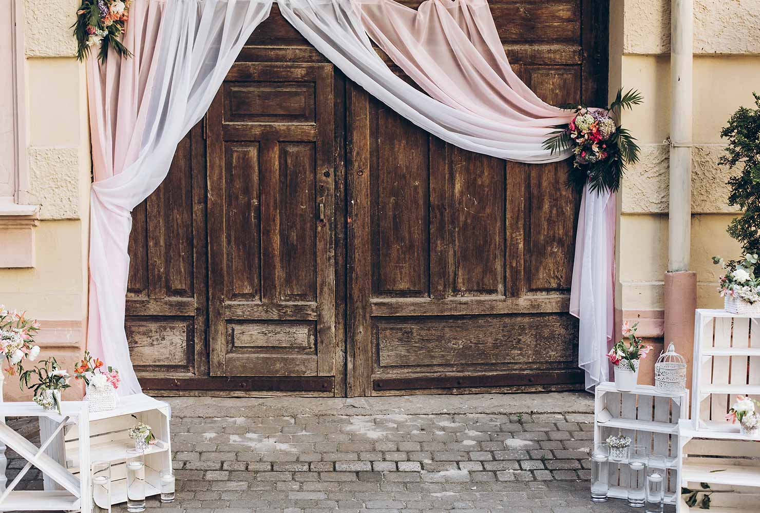 Rustic door with blush curtains.