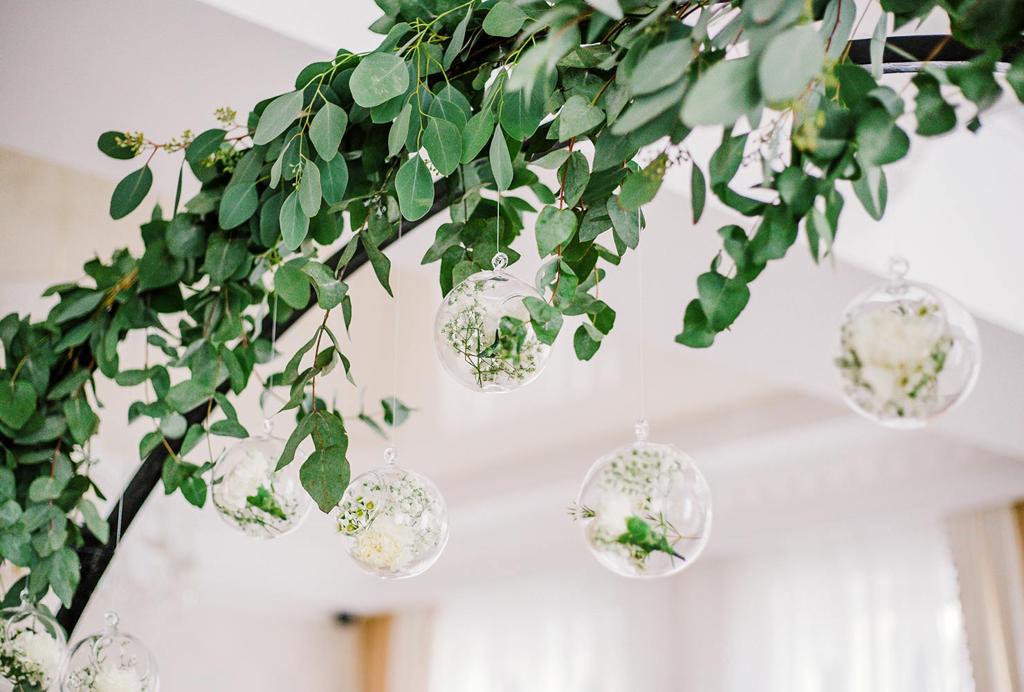 Simple sage greenery and glass ornaments.