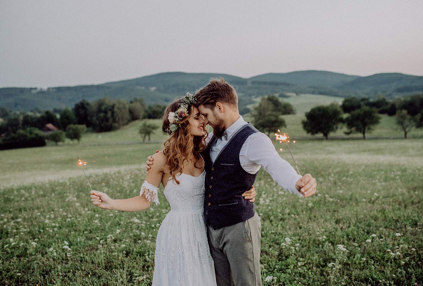 Bride and groom in an open field.