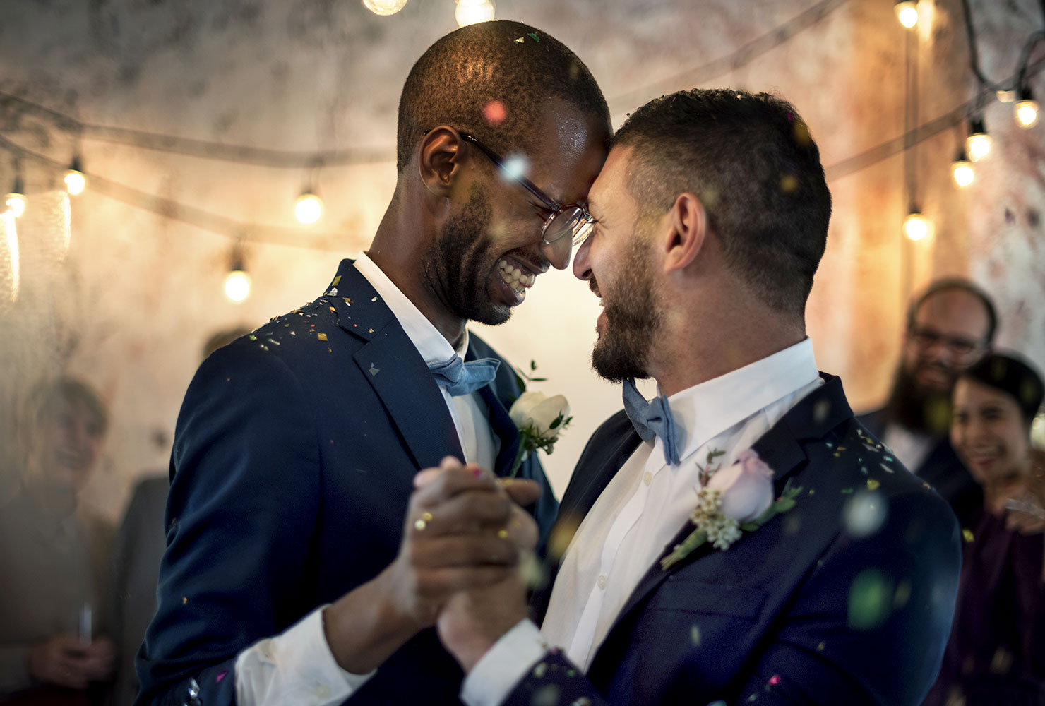Two grooms dance at their wedding