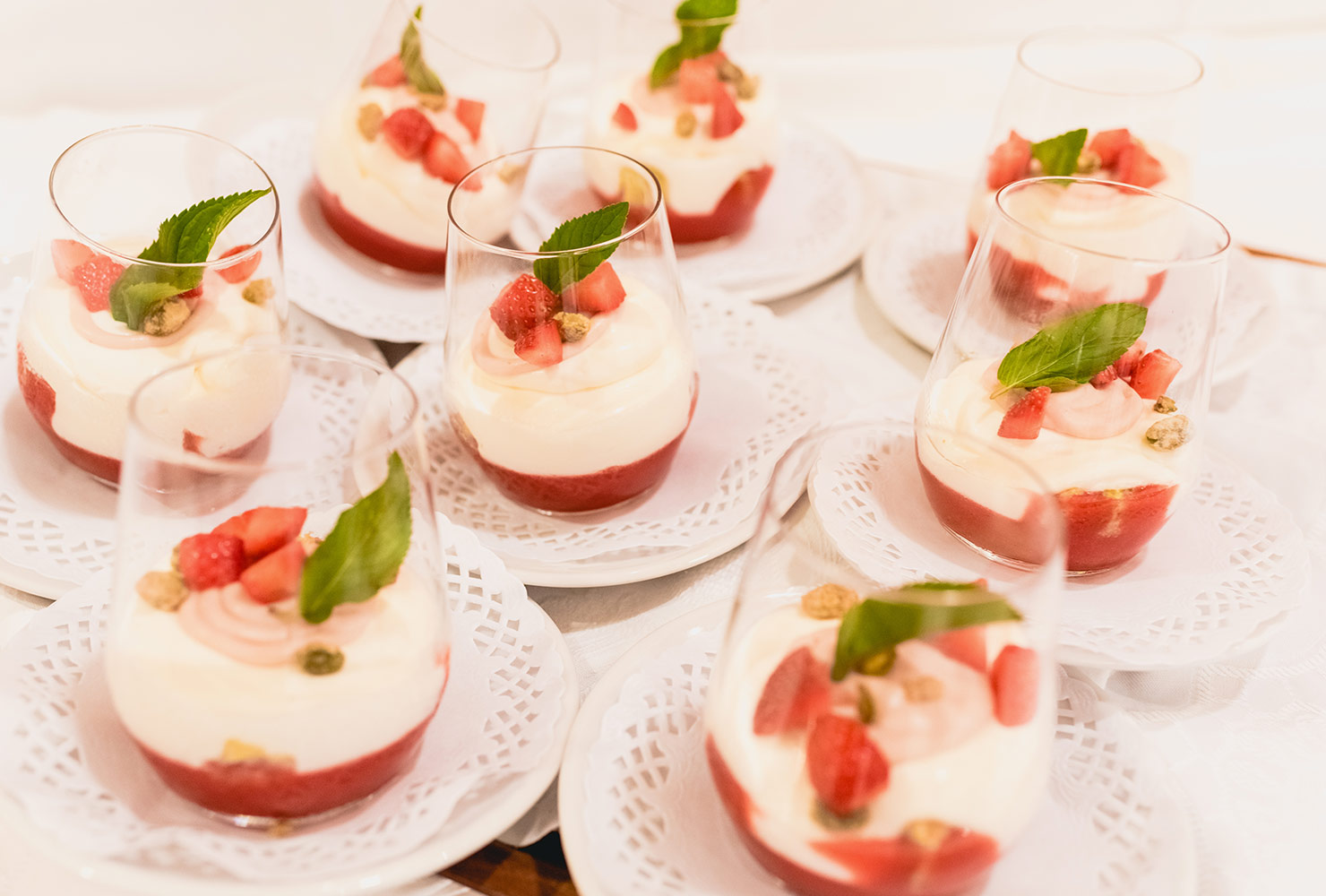 Plates of strawberry pudding parfait desserts.