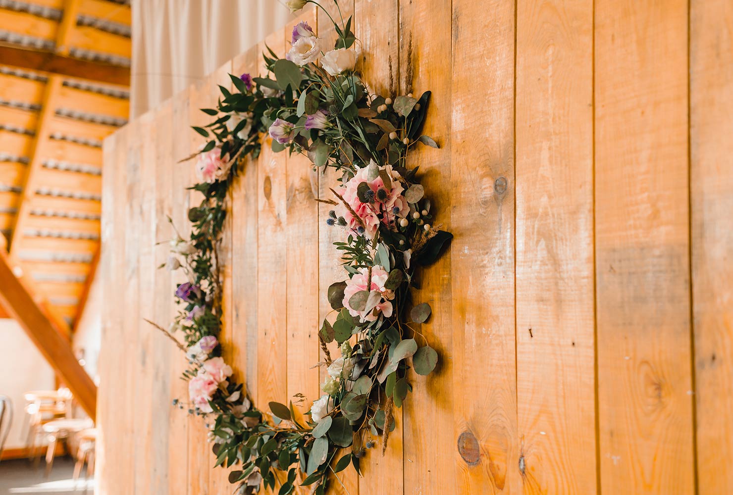 Floral wreath on wood wall.